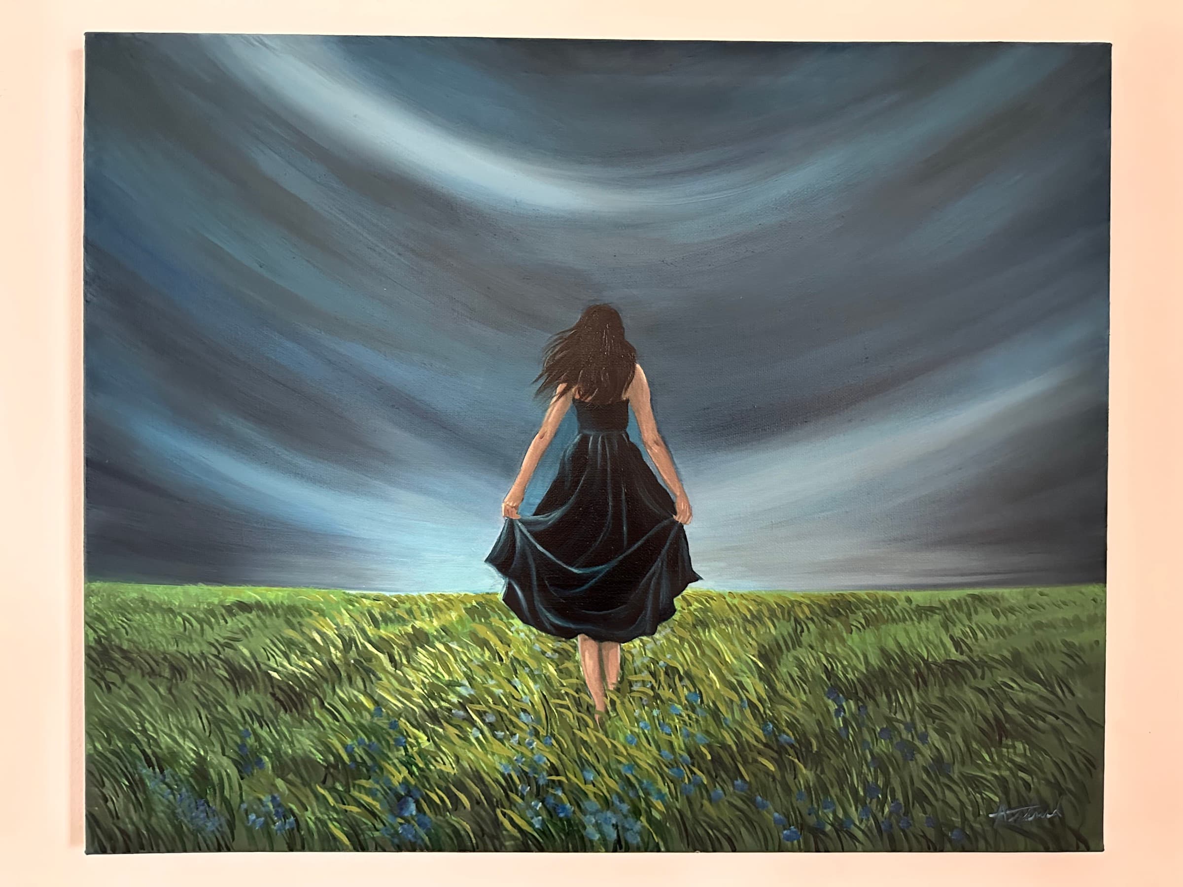 Painting of a woman seen from behind in a black dress walking through a field of green grass with blue flowers, under a dramatic sky of swirling grey clouds